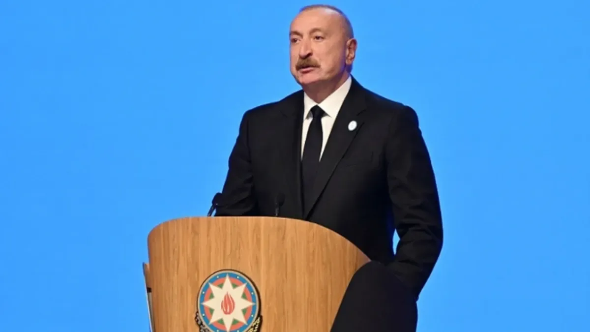 Azerbaijani President Ilham Aliyev speaking at a podium during remarks that stirred debate in Türkiye over support during the Karabakh war