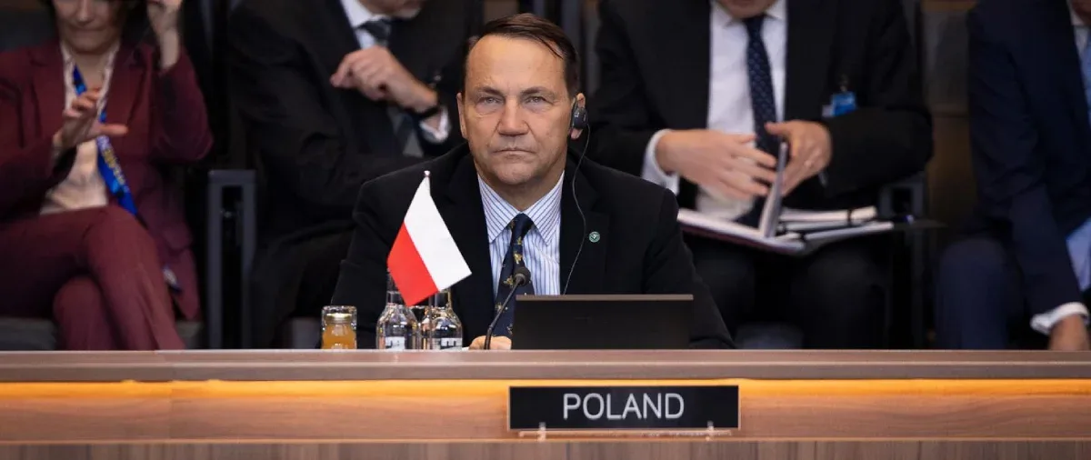 Polish Foreign Minister Radosław Sikorski seated at a NATO foreign ministers meeting in Brussels